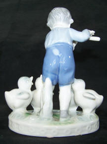 males-boy-plays-flute-to-chicks-back view